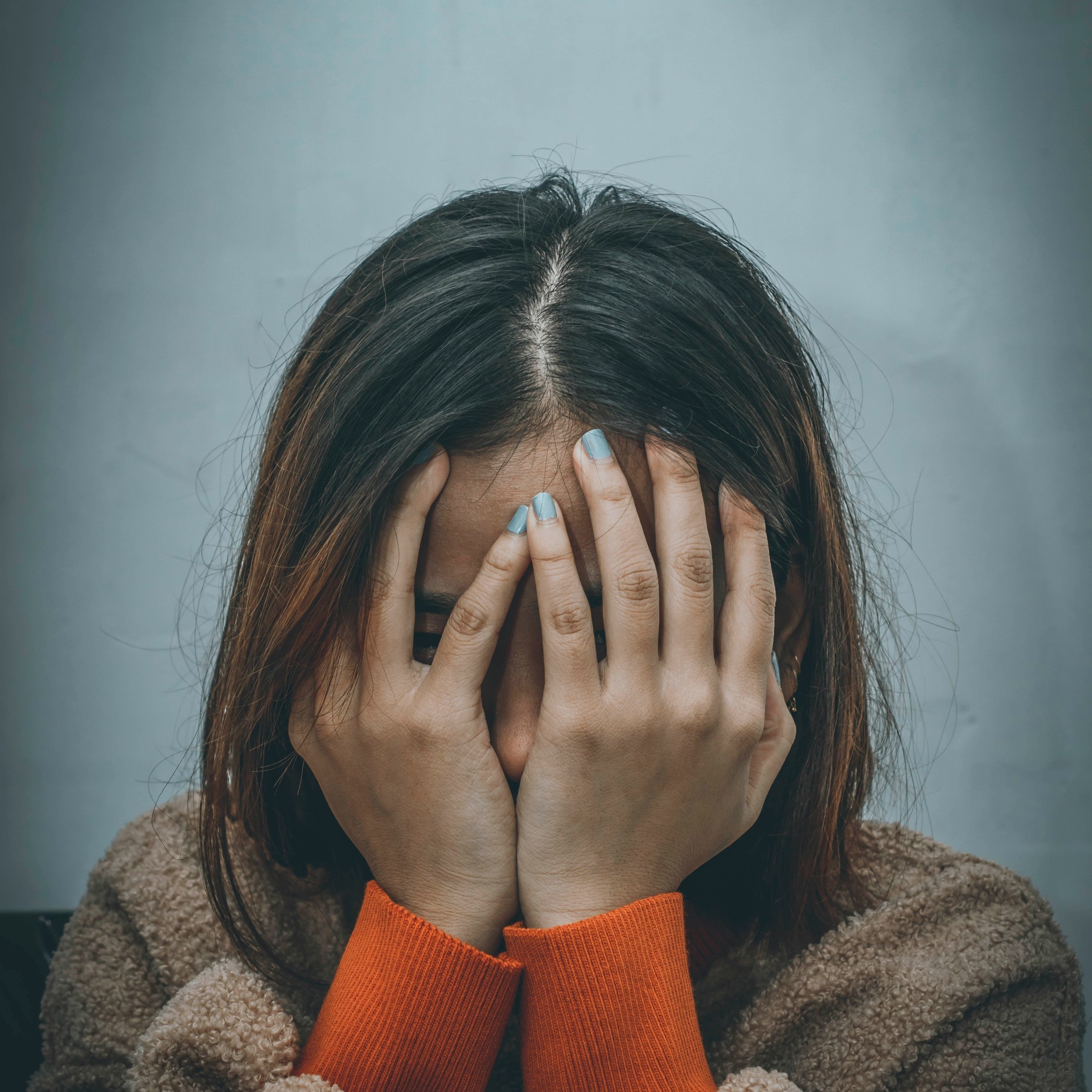 Woman with hands on face